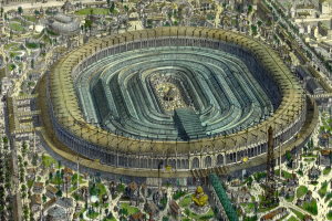 Luftaufnahme eines großen Stadions umgeben von Stadtgebäuden, Bäumen und Gras.