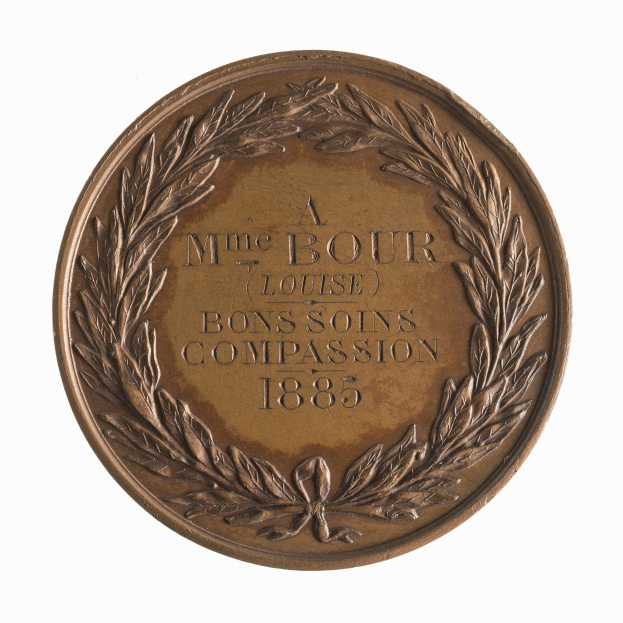 Bronze-Medaille mit Lorbeerkranz-Design und der Beschriftung "Bons Soins Compassion" auf wei├čem Hintergrund.